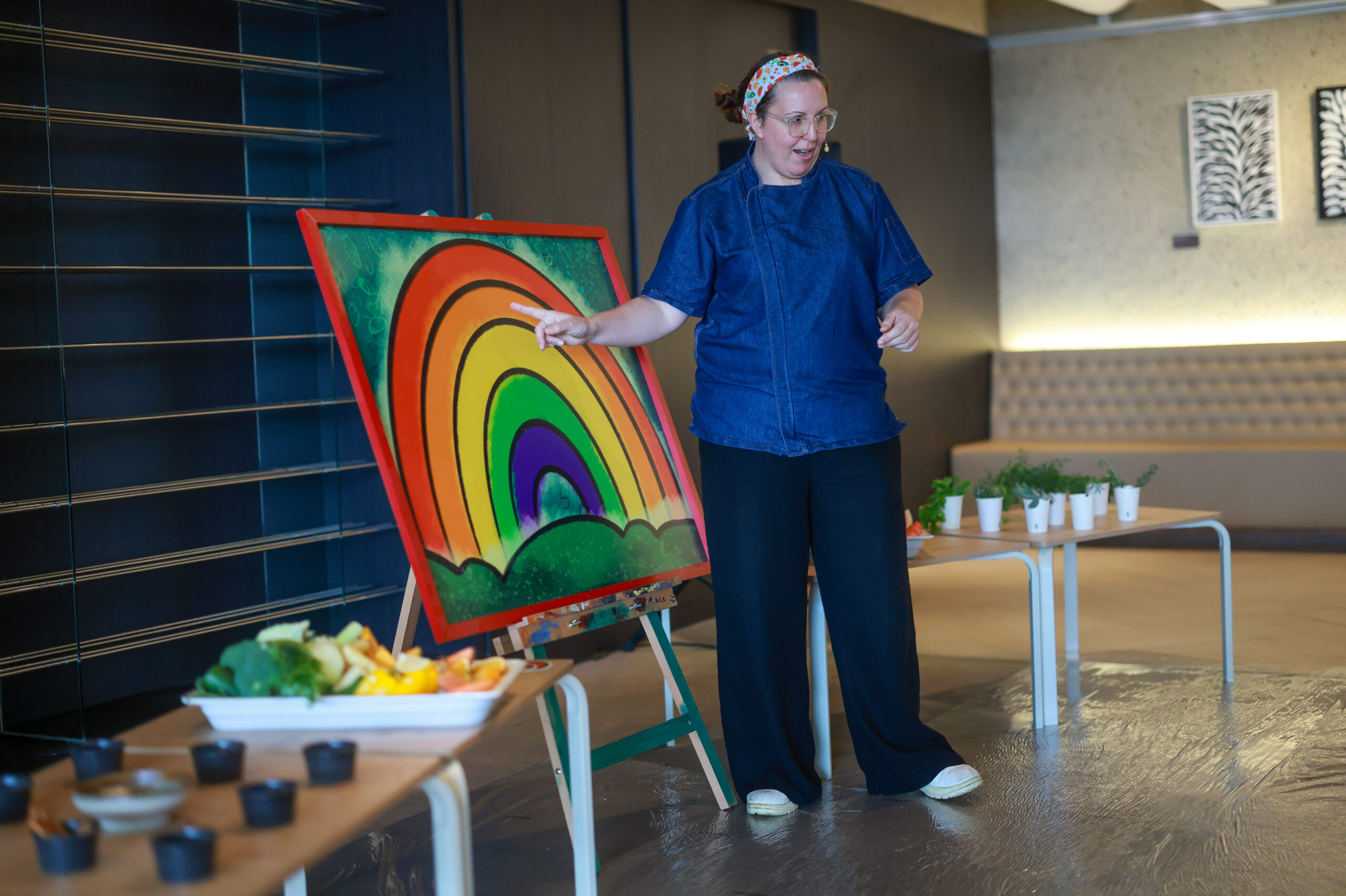 Chef Luisa Scrimshaw demonstrating a cooking technique to students during a school incursion
